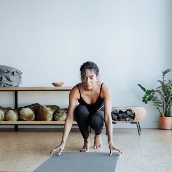Person in a warrior yoga pose looking focused and full of energy.